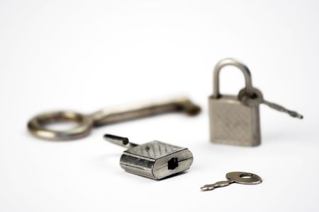 Two little padlocks and keys isolated