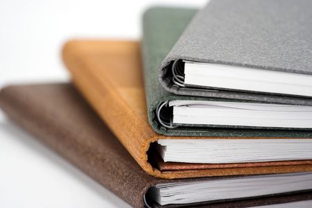Stack of notebooks  with color cover over white