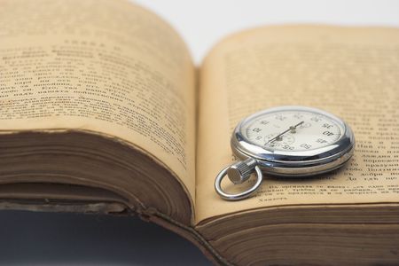 vintage watch over old bookの写真素材