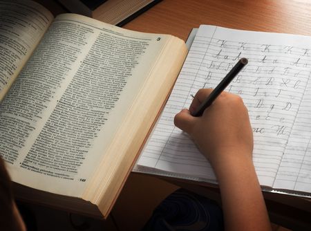 A young schoolboy write his homeworkの写真素材