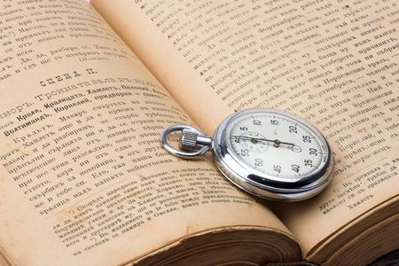 vintage watch over old bookの写真素材