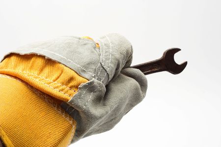  wrench and leather glove over whiteの写真素材