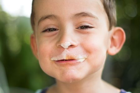 boy eating ice-cream close upの写真素材