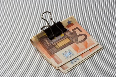 euro bills in a binder clipの写真素材