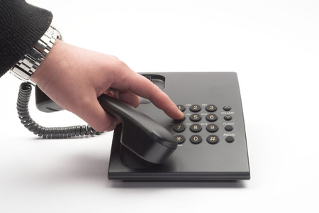 dial with a black office telephone over whiteの写真素材