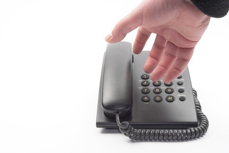 dial with a black office telephone over whiteの写真素材