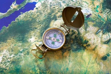 compass close up,map in the background