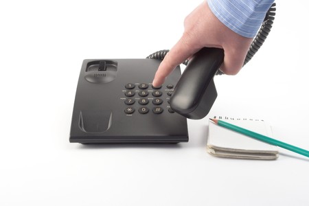 dial with a black office telephone over whiteの写真素材