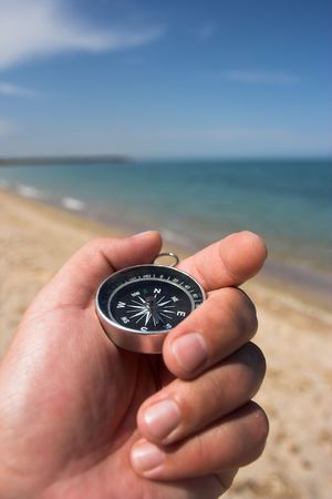 compass in the hand,beach in the backgroundの写真素材