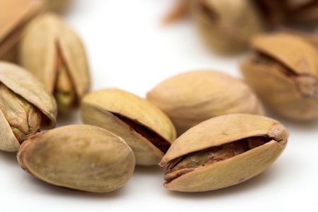Pistachios close up over whiteの写真素材