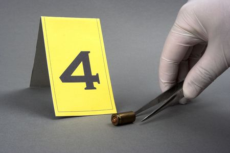 collect evidence-an investigator collect fired cartridgeの写真素材