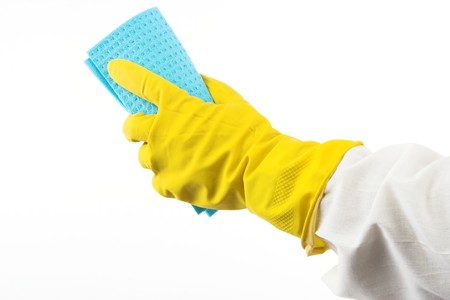 Hand in yellow glove with sponge,over white