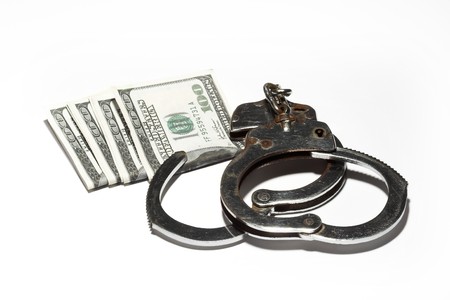 Close-up of  handcuffs and dollar billsの写真素材