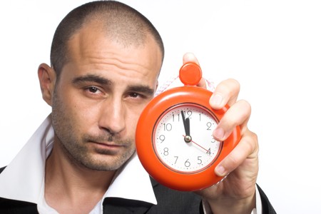 time for work concept-man holding clock over whiteの写真素材