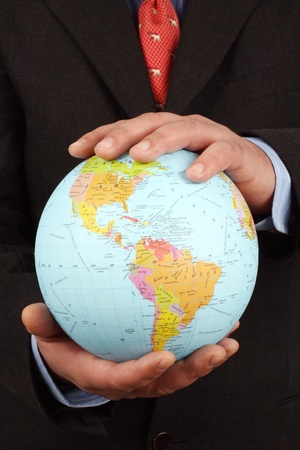 Businessman holding Earth globe in his handsの写真素材