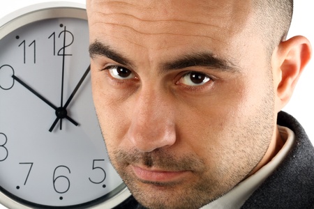 Close up portrait of a businessman and clock. Time for work conceptの写真素材