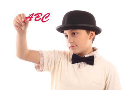 Young  boy with bowler hat writing alphabetの写真素材