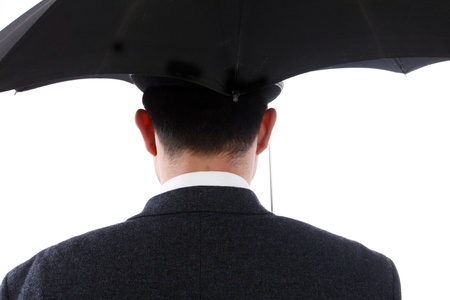 Man with bowler hat and an umbrella in the backの写真素材