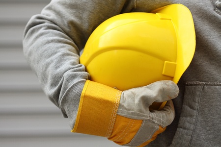 Man holding yellow helmet close up Man holding yellow helmet close up