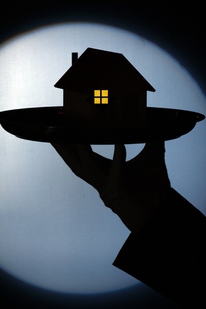 silhouette of a model of house on the tray. Real estate conceptの写真素材