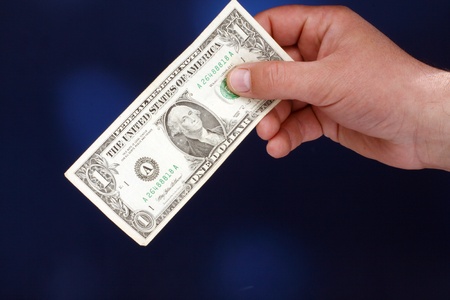  male hand holding a one dollar billの写真素材