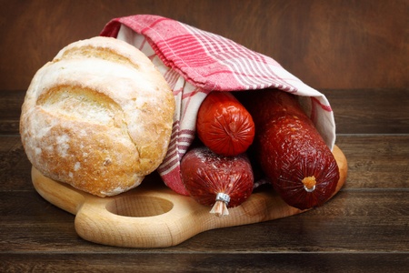 Close up of salami sausage and bread on kitchen tableの写真素材