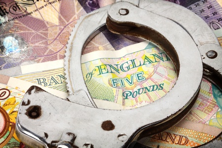 handcuffs and British money close up の写真素材