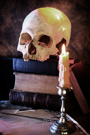  human skull and an old book  search of knowledge concept の写真素材