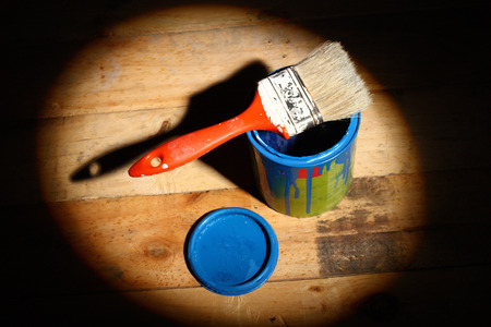 brush painting on tin can of blue paint  in the spotlightの写真素材