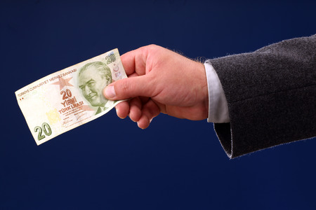 male hand holding a twenty Turkish Liras billの写真素材