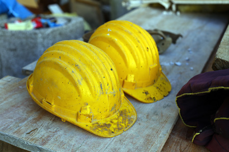 two yellow helmets on work placeの写真素材