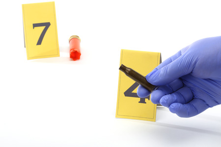 An investigator collect fired cartridgeの写真素材