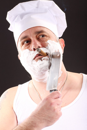 chef shaves with chopper over blackの写真素材