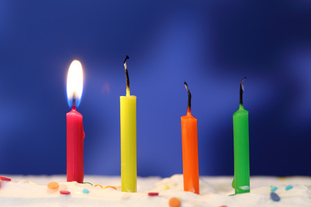 Four lit birthday candles close up, shallow dofの写真素材