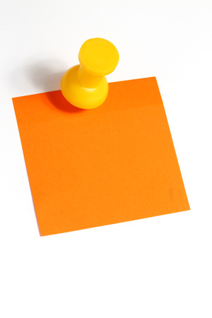 Orange reminder note with yellow big  pin.の写真素材