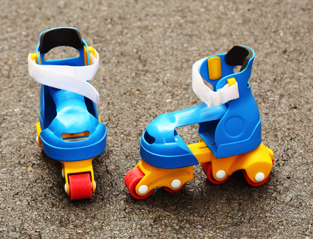 Colored plastic roller skates left in the street