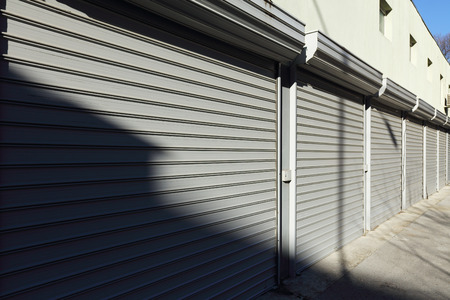 corrugated metal doors of garages, light and shadowの写真素材