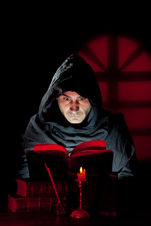 A Monk read mystical occult book in the darkの写真素材