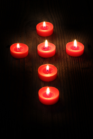 burning  candles arranged in a cross, shallow dofの写真素材