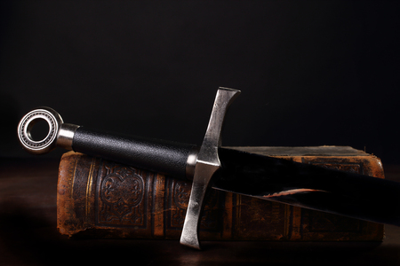 sword and old book close up