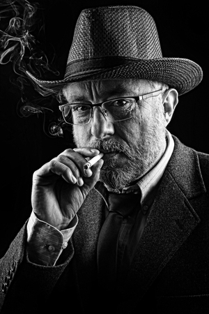 Portrait of a smocking man, black and whiteの写真素材