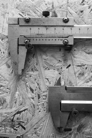 calipers on the wall, close up, black and white