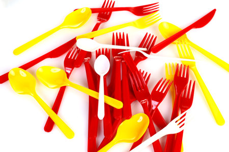 some colored plastic utensils on white