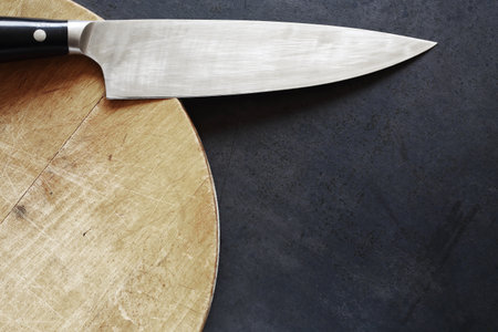 a  kitchen knife on wooden table