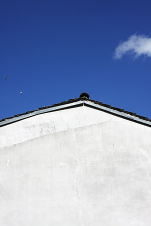 An abstract blind white facade and blue sky