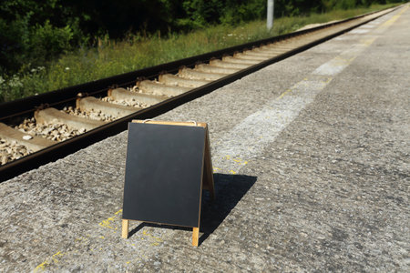 blank blackboard on the railroad.concept for different guidelines, tips and hintsの写真素材