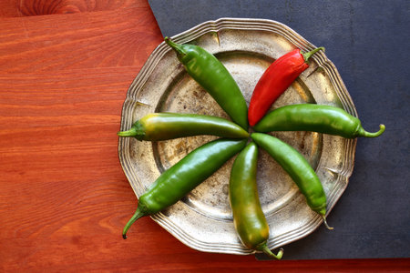 Several green and one chili peppers, top viewの写真素材