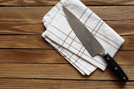 chef's knife on a cloth on a kitchen tableの写真素材