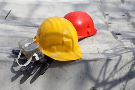 safety first yellow and red helmets at the work placeの写真素材