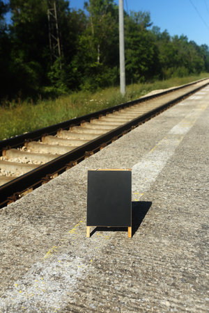 blank blackboard on the railroadの写真素材